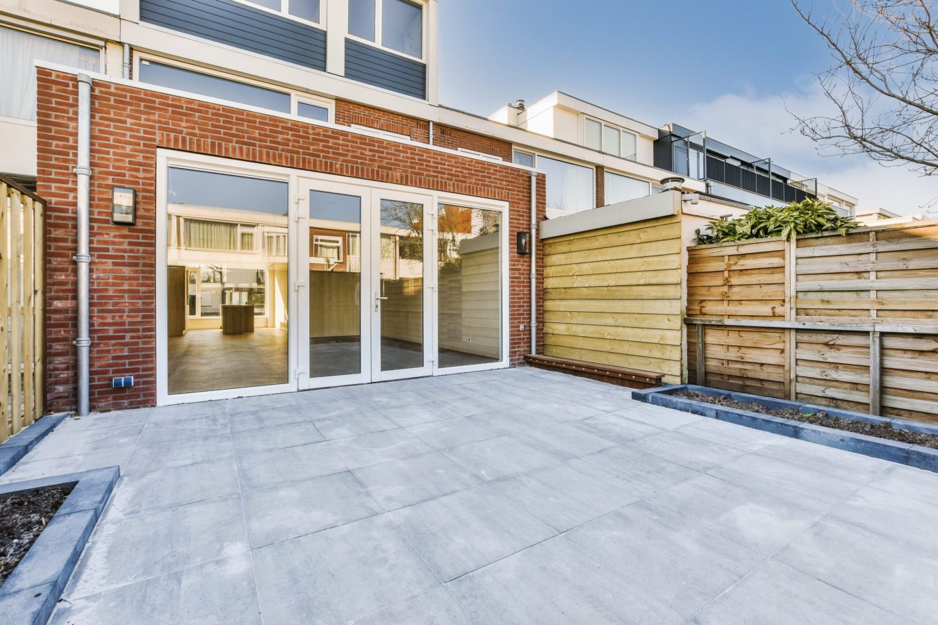 Neat paved patio near wooden fence